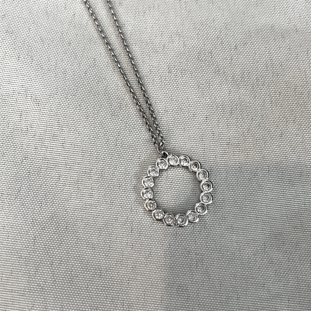 Kate Spade silver necklace with sparkly pendant.
